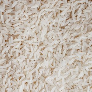 Detailed texture of uncooked white rice grains, perfect for food-related content.
